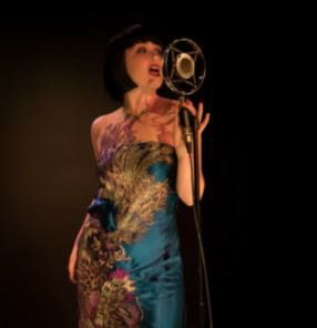 Woman singing at the Boxcar Theatre